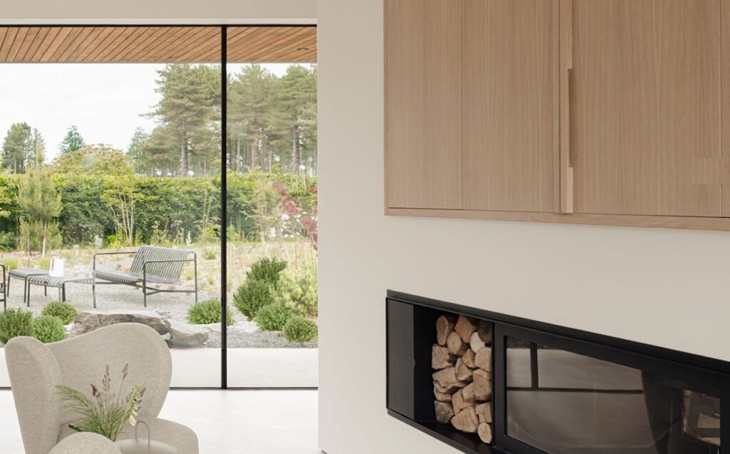 Contemporary interior. Calm, modern aesthetic. Large window looking into garden.