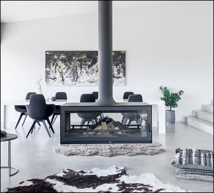 Suspended fireplace in the centre of a modern room.
