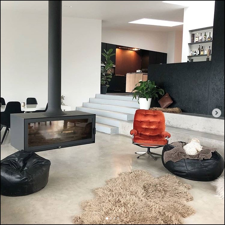 Suspended fireplace in the centre of a modern room.